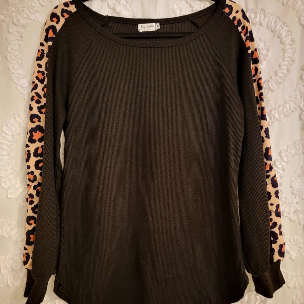 Black sweater with Leopard print on sleeves.